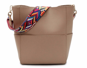 Solid color leather bucket bag with a color strap