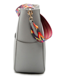 Solid color leather bucket bag with a color strap
