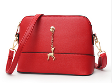 Shell high quality leather bag in solid colors.