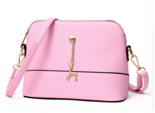 Shell high quality leather bag in solid colors.